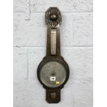 A carved oak barometer