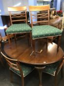 An Edwardian mahogany wind out dining table and eight dining chairs (6+2)
