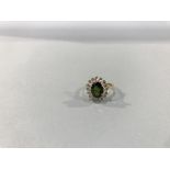 An 18ct gold diamond and emerald ring, 3.8g, size 'J'