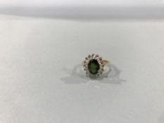 An 18ct gold diamond and emerald ring, 3.8g, size 'J'