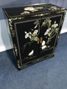 An Oriental lacquered two door cabinet, 59cm wide