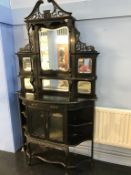 A Victorian ebonised mirror back cabinet