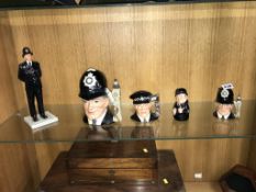 Five Royal Doulton Police figures and Toby jugs
