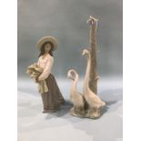 A Nao figure of a girl and a Nao table lamp with swans