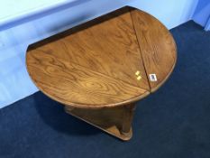 A triangular oak drop flap table
