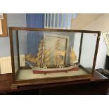 A model of a boat, cased