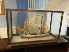 A model of a boat, cased