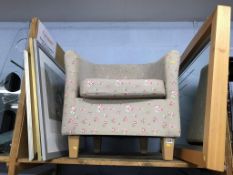 An armchair and various prints