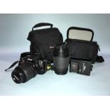 A Nikon D3100 spare lens and carry cases