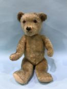 A plush jointed teddy bear, 58cm tall