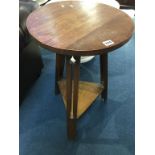 An oak circular tripod table
