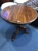 A reproduction mahogany tripod table