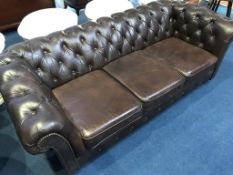 A brown leather Chesterfield settee