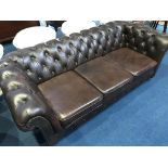 A brown leather Chesterfield settee