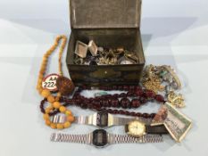 A tin of assorted jewellery and wristwatches etc.