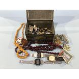 A tin of assorted jewellery and wristwatches etc.