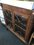 A Continental mahogany glazed bookcase