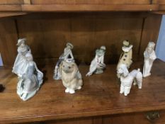 Three Lladro figures, two Lladro dogs, two Nao clowns and a Nadal figure (8)