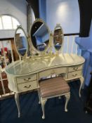 A cream dressing table and stool