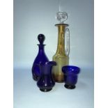 Three pieces of Thomas Webb blue glass, and an amber coloured decanter