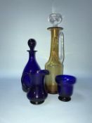 Three pieces of Thomas Webb blue glass, and an amber coloured decanter