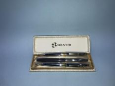 A boxed Sheaffer pen and two Cross pens