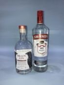 A bottle of 'Hrafn Gin' and a bottle of Smirnoff vodka