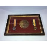 A framed, mounted first World War pair of medals, and a death plaque to William Henry Dunkeld