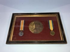 A framed, mounted first World War pair of medals, and a death plaque to William Henry Dunkeld