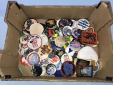 A collection of various vintage pin badges and patches