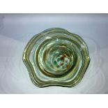 A waved edged coloured glass circular bowl