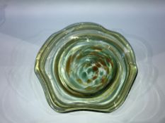 A waved edged coloured glass circular bowl