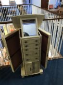 A cream painted jewellery cabinet