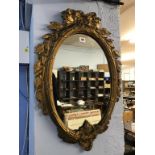 An ornate gilt framed mirror