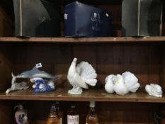 A Lladro dolphin, riding a wave, a Lladro dove, a pair of Lladro courting doves, a rabbit and a