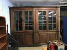 A large late 19th century early 20th century, oak four door bookcase, with added cornice, below four