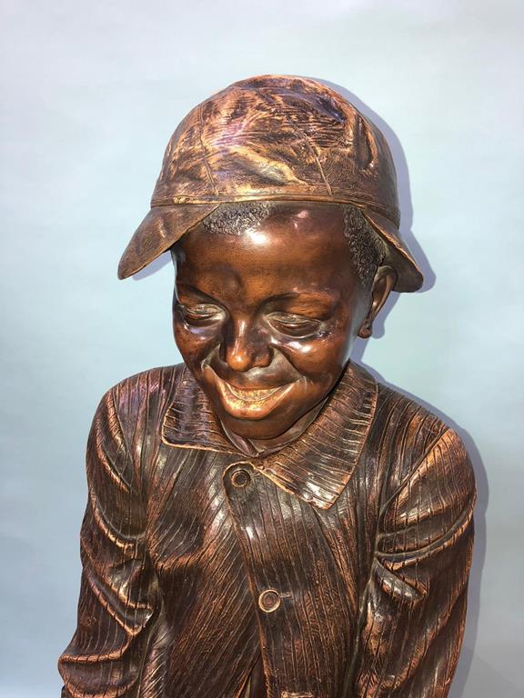 Frederich Goldscheider, a painted terracotta, life size, seated young boy, wearing a cap, hands - Image 11 of 18