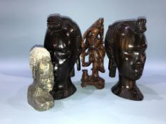 A pair of carved tribal busts, a hardwood Oriental carved figures and a soapstone bust