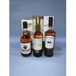 A bottle of Bowmore '12' year old whisky, a bottle of Talister '10' year old, and a bottle of 'Sheep