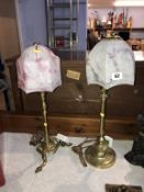 An Art Nouveau brass table lamp and an Edwardian brass table lamp, with shades