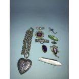 A silver and mother of pearl fruit knife, three enamelled brooches, three decorative brooches and