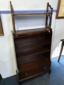 A Stag graduating bookcase and small wall shelves