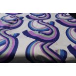 A roll of pale mint green fabric, with psychedelic pattern in purple, green and blue, 173cm wide x