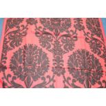 Three pieces of woven fabric, the crimson ground with black floral decoration, 126cm wide x 1m 50cm,