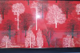 A framed panel of fabric, the red ground with black and white silhouette tress, 116cm wide x 46cm