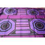 A piece of fabric, Edinburgh Weavers, the purple ground with a large geometric design in purple