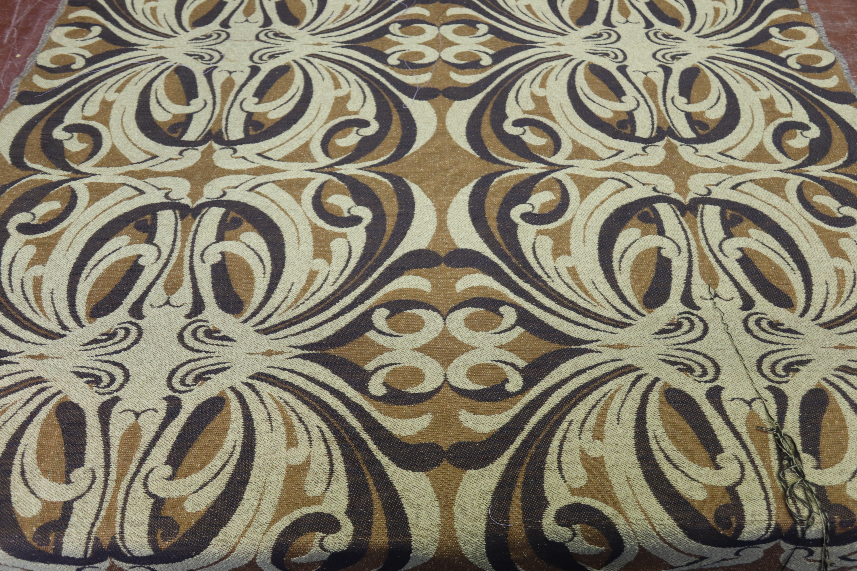 A roll of woven fabric, "Lombardy" by Edinburgh Weavers, large scrolling abstract pattern in