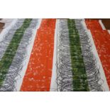 A piece of screen printed fabric, in orange, green and black, 123cm wide x 430cm long