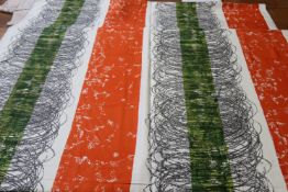 A piece of screen printed fabric, in orange, green and black, 123cm wide x 430cm long