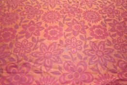 A roll of woven fabric, with cerise and burnt orange Sunflower design. 128cm wide x 16 metres 68cm